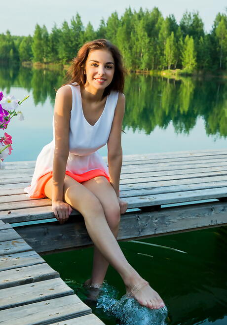 Slender ukrainian youthful Evita Lima in skirt revealing big titties and shaved pussy outside